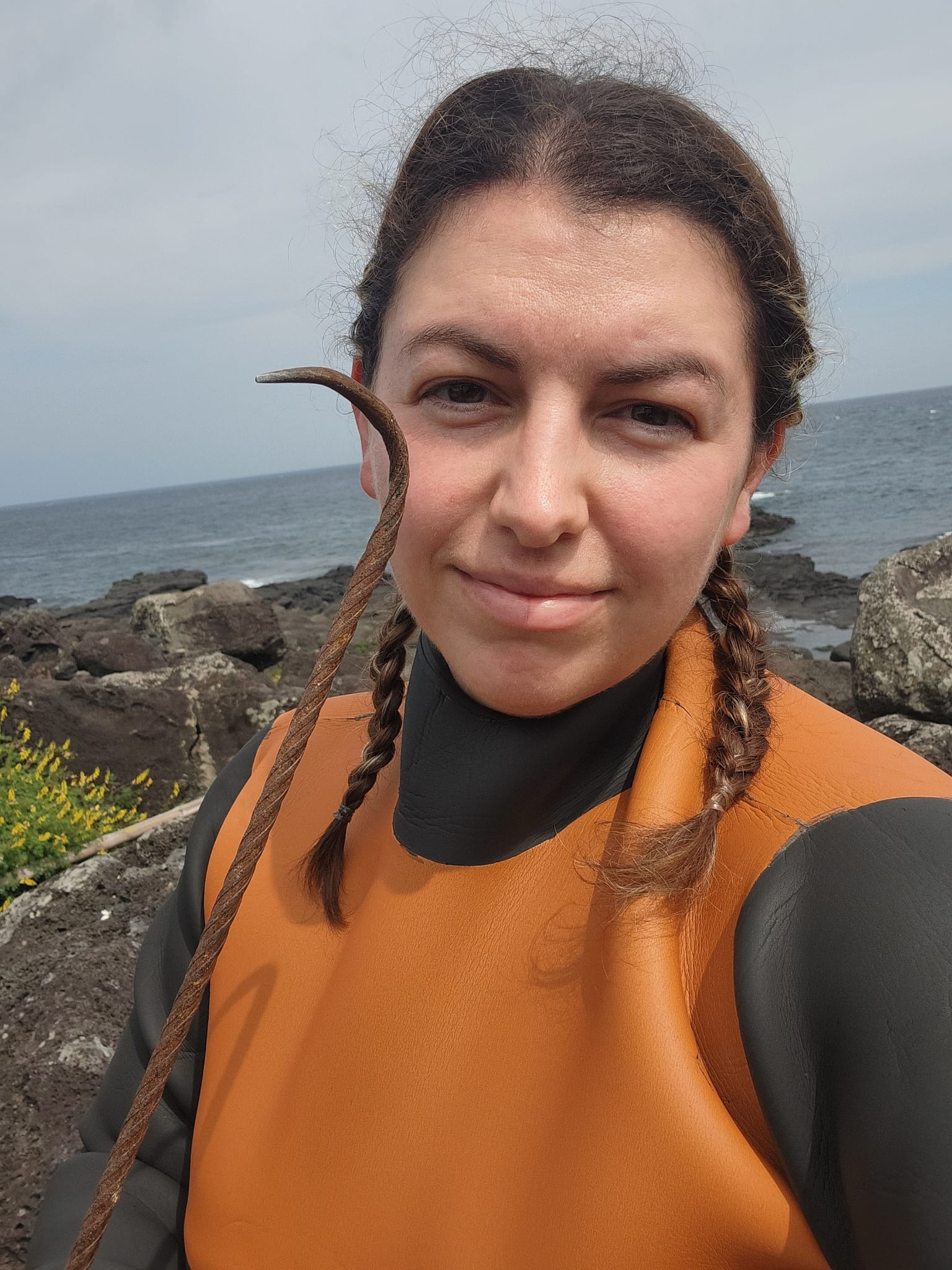 Kylie, a licensed haenyeo, in her diving suit on the Jeju coast